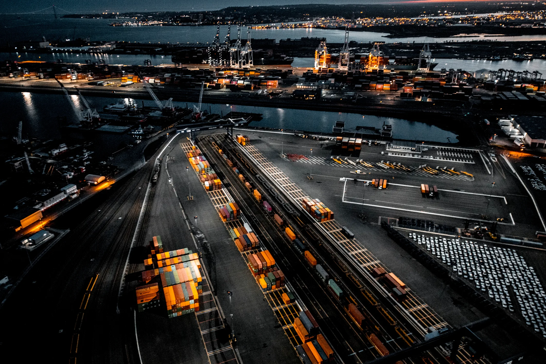 Aerial view of Port Newark-Elizabeth at dusk, container yards illuminated by sodium-vapor lights